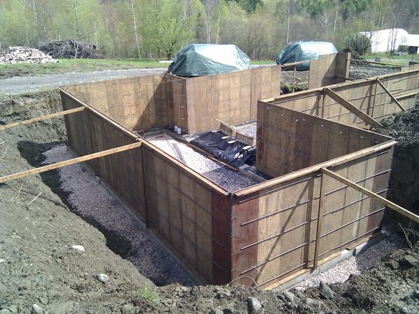 Forms in place for foundation walls to be poured. Lots of stone under and around the footings for drainage.  The foundation was the only piece of the house that we did not build ourselves.
