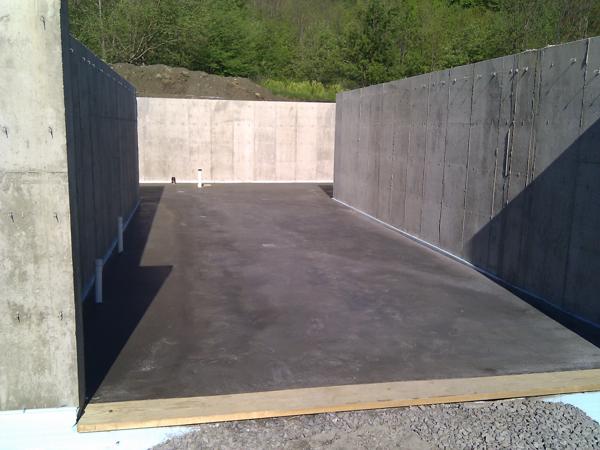 Finally, the slab has been poured, with drain pipes protruding.