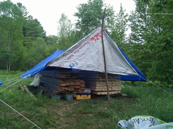 A tarp tent I rigged up to protect some of the decking and sheathing that won't be used right away.