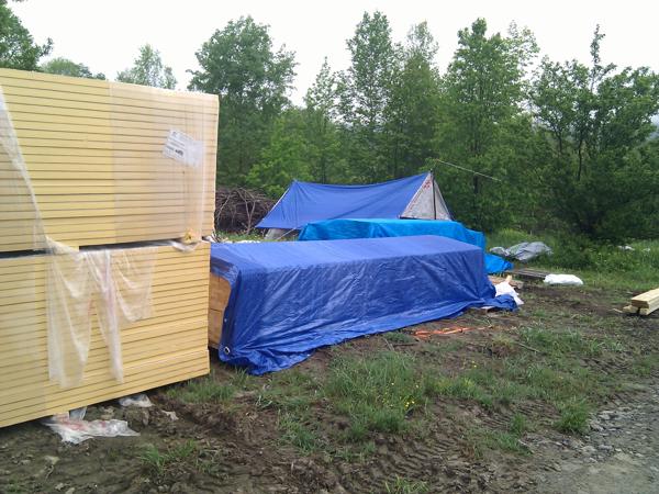 The first load of wood and foam insulation stacked up on palettes near the house site.