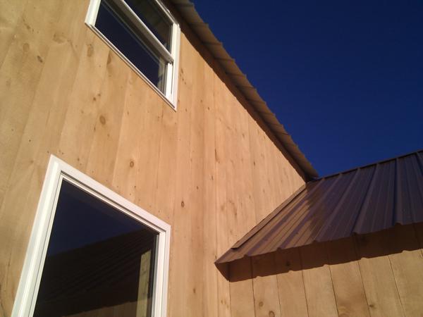 Putting up the siding over the one story roof was very difficult and took two days.  The piece at the very peak, barely visible in the picture, was the worst; we should have glued it in place instead of trying to nail it.