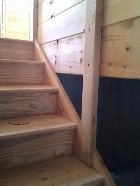 Our first attempt at interior framing was the wall around the basement stairs.  We chose to hide the studs inside the opening, which required some tricky cuts at the bottom of the studs where they meet the stairs.