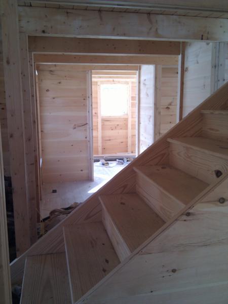 The rest of the interior framing has proceeded fairly quickly.  The picture shows parts of the walls for the basement stairs, the bathroom, and the bedroom.  We chose to use screws instead of nails to attach the studs to the floor and beams; the studs don't move using this method.