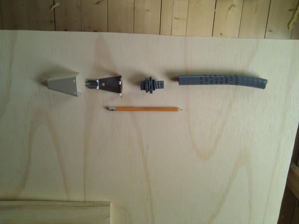 The components making up the transition from Wiremold raceway in the first floor to the Romex cable in the basement.