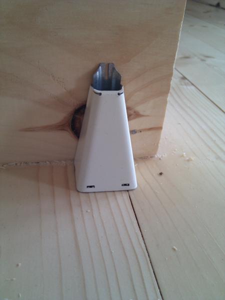 The hole bringing wires up from the basement is covered by a Wiremold connector.