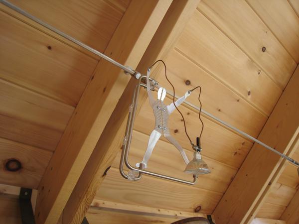 Three of the kitchen track lights are metal men holding 50 watt MR-16 bulbs.  These are bright enough to cover most of the kitchen counter.