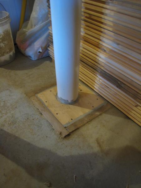 The radon pipe enters the basement slab through an opening that was originally meant for a shower drain, and rests on the gravel beneath the slab.