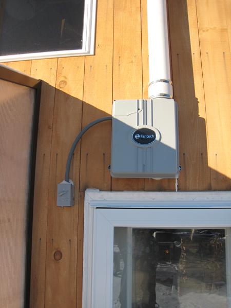 The radon fan is mounted outside the house, just above the walkout basement door.