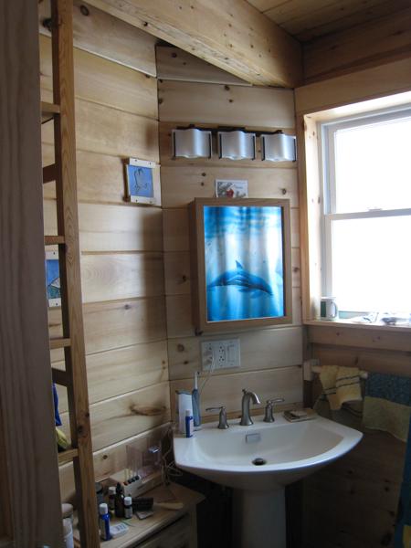 Downstairs bathroom sink, with electrical and plumbing hidden behind an angled false wall.