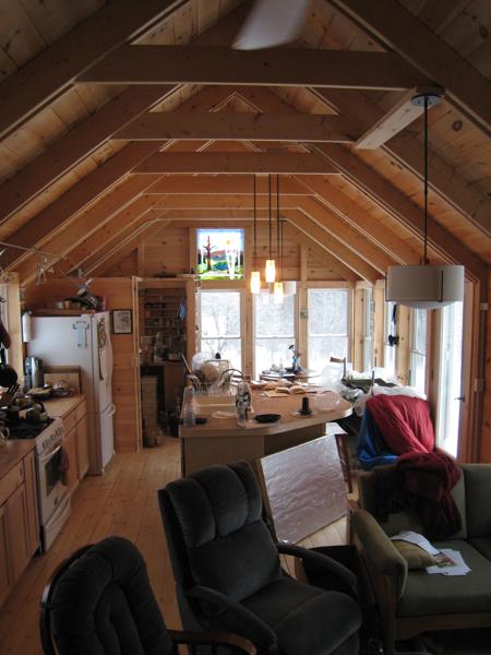 View of the one story section (living room, kitchen, dining room) from the two story section.