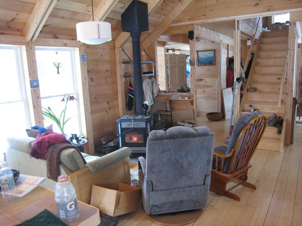 The living room is simply a cluster of seats around the wood stove.