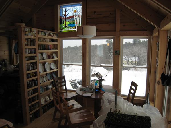 The dining nook against the east wall, with the pantry on the north side.  The east wall is topped with a stained glass window made by a good friend.