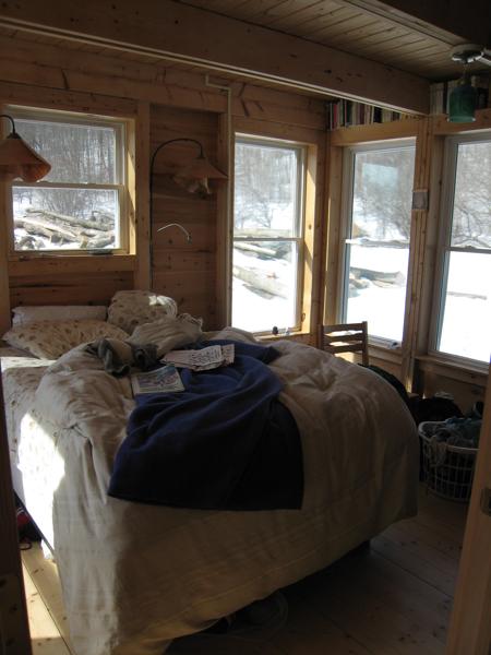 The downstairs bedroom has windows on three sides, making for a kind of screened-in sleeping porch in summer.