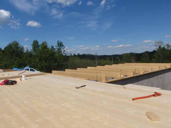 Decking for first floor of two story section nearly complete, with hole for basement stairs. Note the BoWrench on the right.