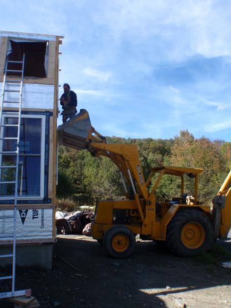 The bucket loader on our neighbor's excavator turned out to be the perfect platform for installing the windows upstairs.
