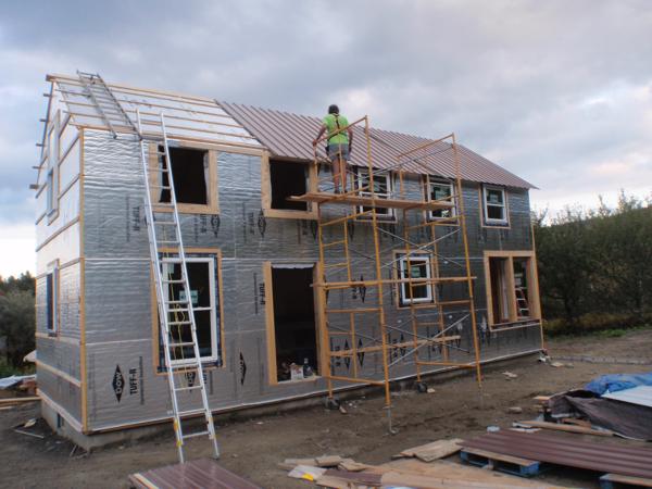 Rented scaffolds made it much easier to install the metal roofing on the two story section.