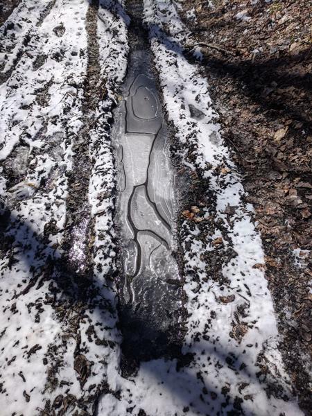 Frozen puddle on trail