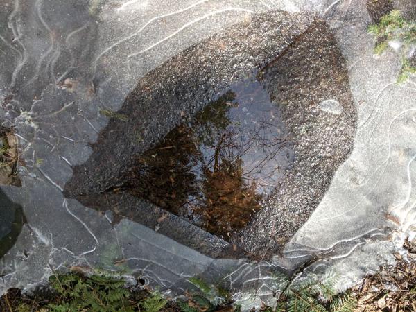 Sky reflection on melting puddle