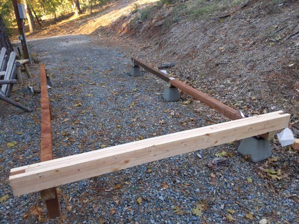 There will be five beams, at 40 inch spacing, creating a 36 inch gap between posts for windows.  Each beam is made from two 2x6 boards with a 2x4 sandwiched in between.