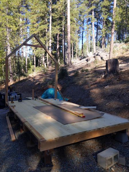 The first bent is up.  Raising it alone was very difficult, due to the weight and size.  I attached 8 foot boards to the sides to act as props, and also used a 12 foot board to push up on the collar tie.  The process is shown in the following photos.