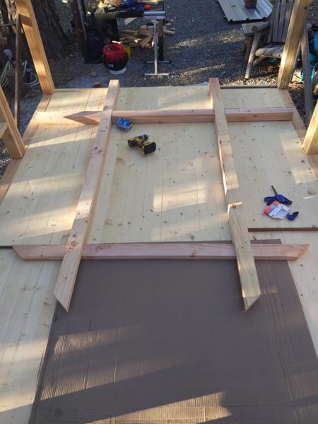 The partially built north wall.  An end wall like this is not a load-bearing structure, so it can be just strong enough to frame a window and provide a nailing surface for the sheathing.  Here the opening is for a 36x54 window.