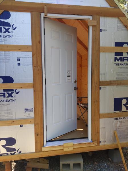 Door is mostly installed.  Here you can see jigs I used to hold it in place during installation.  Eventually the gaps will be filled in with spray foam.