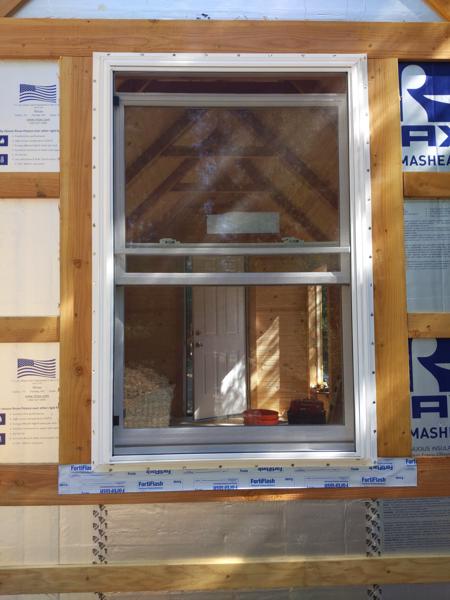 Window on the north gable end. There is flashing membrane under the bottom flange, and eventually more membrane will cover the side flanges and then the top flange.