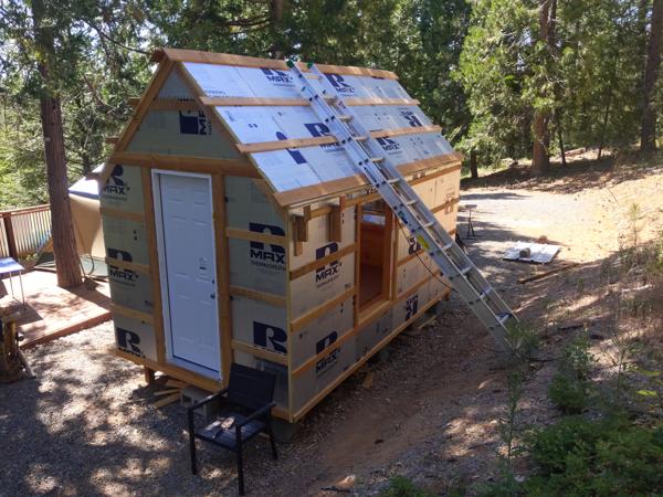 The insulation is complete.  To work on the roof, I'll be using this long extension ladder set at a 45 degree angle directly on the roof, with the bottom of the ladder anchored on the ground.