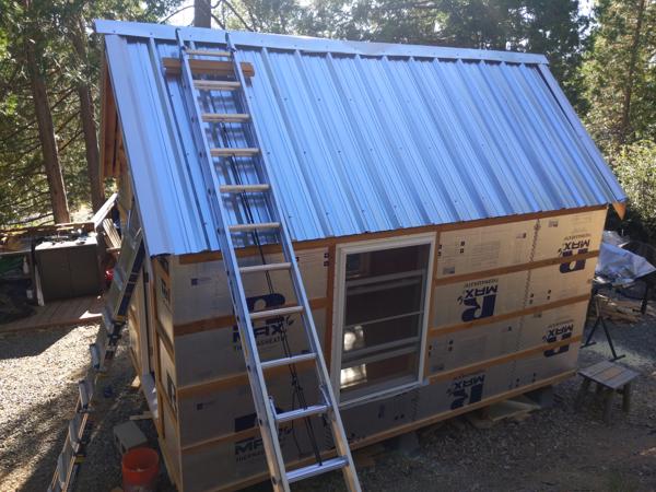 Roof panels on the west side, with the ladder I used to install the panels.