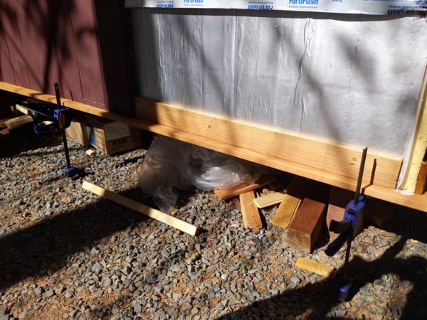 I used a scrap board held against the bottom of the wall to hold the siding in place while screwing it to the strapping.